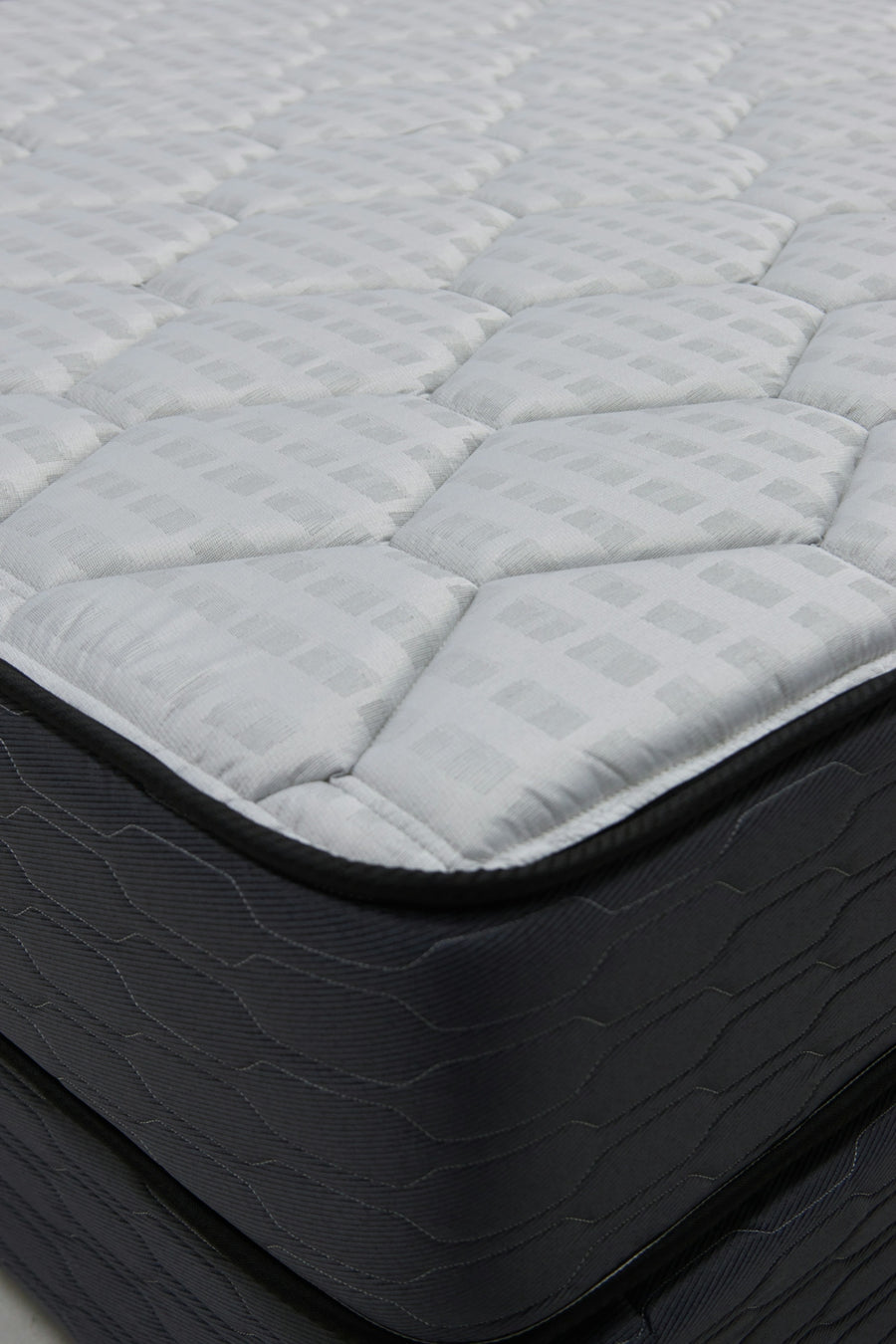 Close-up of a quilted mattress with dark sides